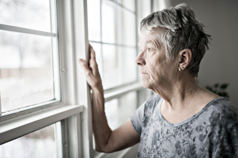 serious mature woman at window